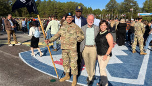 Tony Sarsam and his wife stand with their son Jorge at Fort Benning, Georgia, celebrating with Major General (Ret.) Hawthorne Peet Proctor the completion of Jorge's Basic Training as a new solider in the U.S. Army. Tony Sarsam is CEO of SpartanNash (Nasdaq: SPTN)