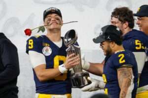 Michigan quarterback J.J. McCarthy #9 celebrates with trophy after defeating Alabama during the 2024 Rose Bowl game Monday, Jan. 1, 2024, in Pasadena, Calif.